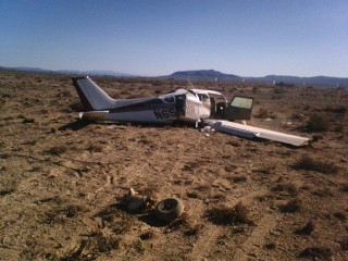 Photo taken from the direction of travel. That's the nose gear in the foreground. The main gear are in the wings.