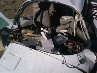 A look into the cockpit. The plexiglass is scatered around the wreckage.